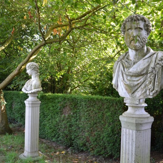 Italienischer Garten Gestaltungsidee - römische Skulpturen schmücken dekorativ den Garten - Bäume & getrimmte Heckensträucher