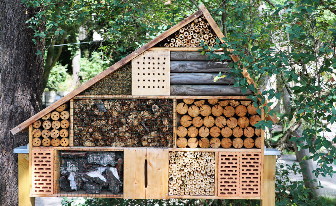 Großes selbstgebautes Insektenhotel im Garten als Gestaltungsidee – Beispiel mit versch...