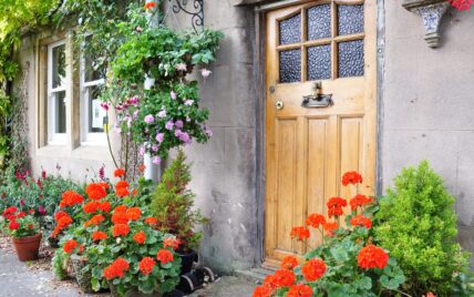 Sommerliche Dekoration eines Hauseinganges mit bunten Blumen