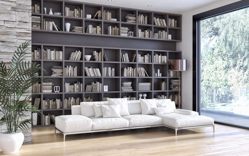 Bibliothek Idee – moderner Einrichtungsstil – raumhohes Bücherregal in dunklem grau & helles Ecksofa für gemütliche Lesestunden