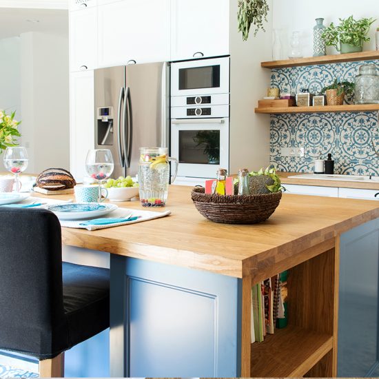 Schöne Küchengestaltung mit einer Kochinsel als Küchentisch & Barhockern - Beispiel mit Dekoration in der Küche  Glasvase & Blumenstrauß