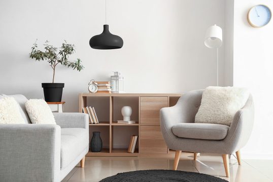 Skandinavisch eingerichtetes Wohnzimmer mit Sessel & Sofa